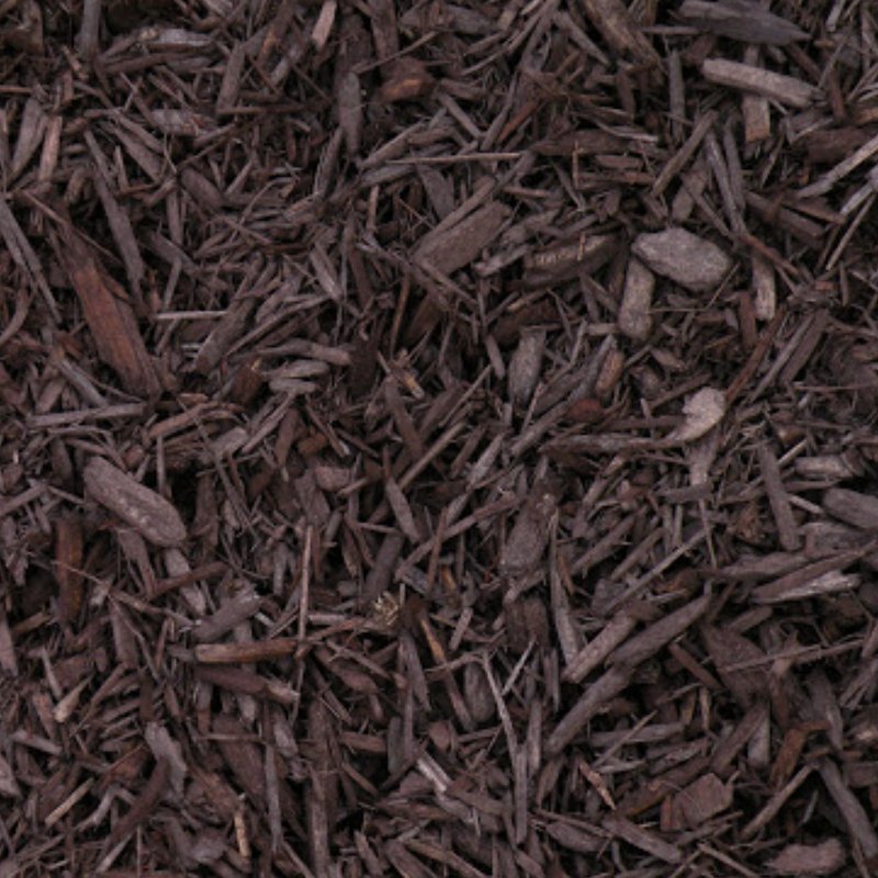 Close-up of dark brown mulch composed of small wood chips and shavings, ideal for garden landscaping and soil protection.