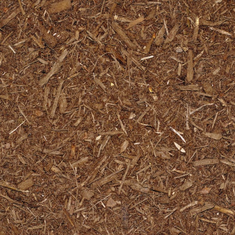 Brown mulch composed of small wood chips and fibrous material, creating a rich, textured surface ideal for gardening.